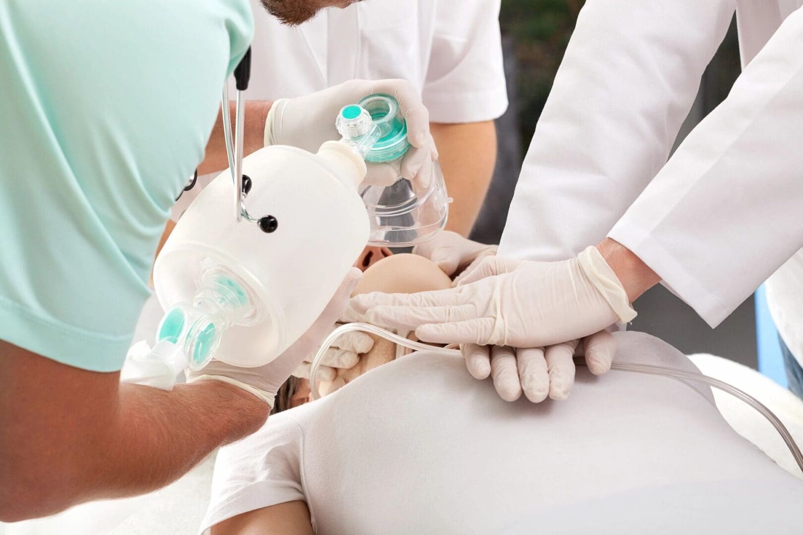 A group of doctors are holding hands and operating on someone.